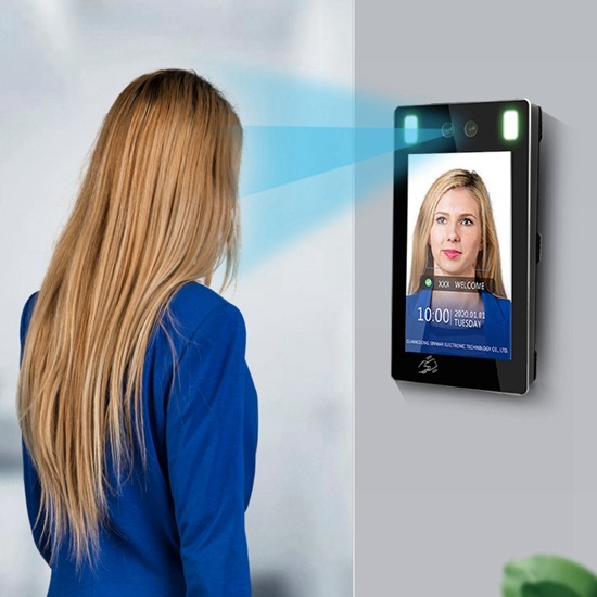 AI face recognition attendance terminal mounted at an office entrance