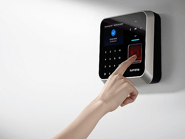 Employee checking in on a wall-mounted fingerprint terminal